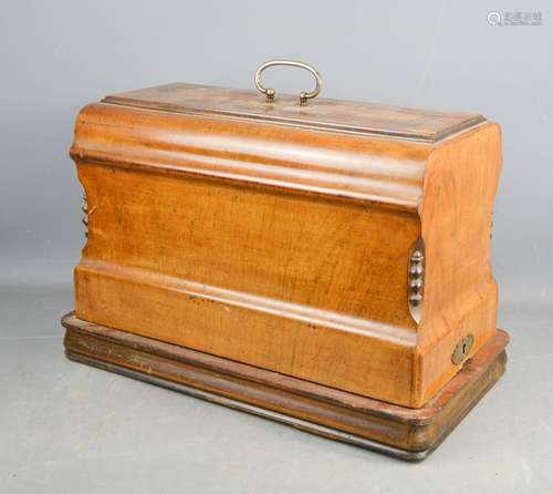 A sewing machine in a marquetry mahogany case.