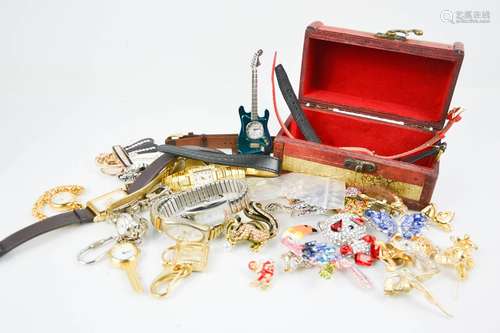 A group of watches, to include one in the form of a guitar, a box containing jewellery.