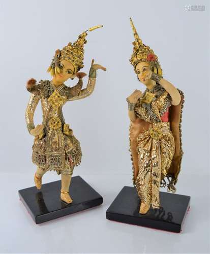 A pair of Indonesian figures on stands