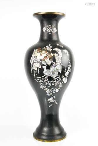 A Chinese black enamel and mother of pearl inlaid vase, depicting peacocks and flowers, 60cm high.