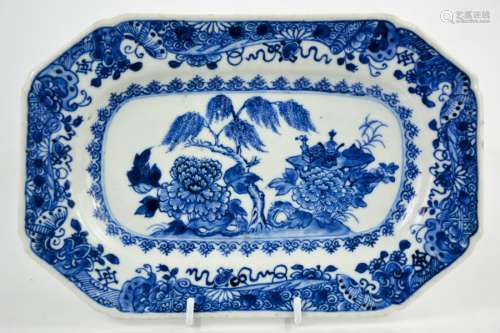 A 19th century Chinese blue and white plate, the centre depicting a table laden with auspicious