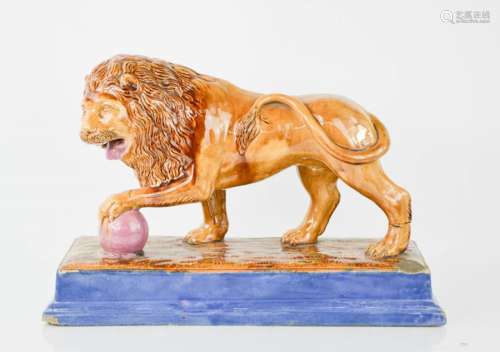 A Victorian Majolica performing lion figure. Standing on rectangular plinth base with mottled glazes