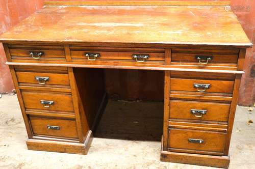 An Edwardian oak pedestal desk.