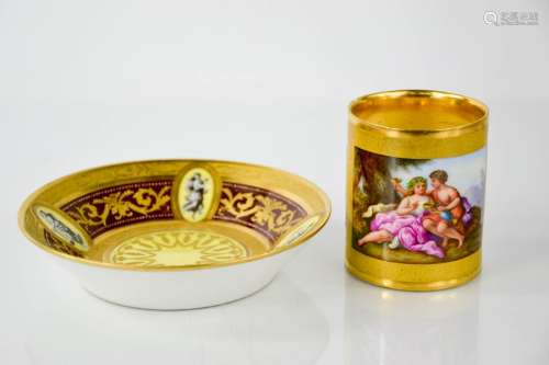 A fine early 19th century Vienna porcelain coffee can and saucer, hand painted to depict courting