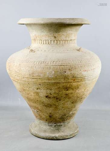 An early Chinese earthenware vase, embossed with decoration, A/F, 46cm high.