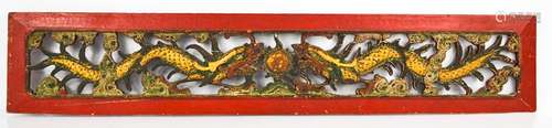 A late 19th century Chinese panel, pierced and carved with dragons and flaming pearl, painted with