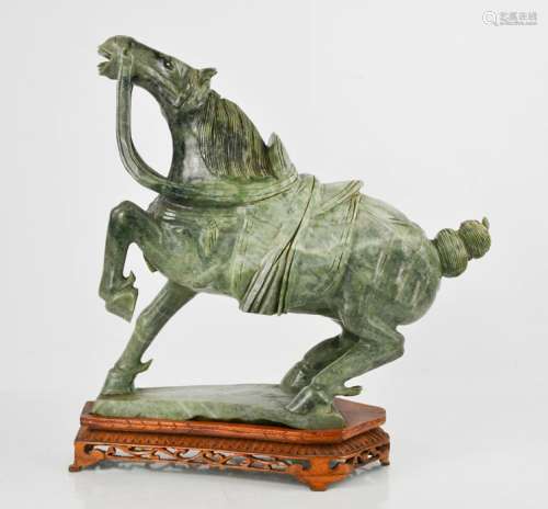 An early 20th century Chinese soapstone horse on wooden stand, 37cm high.