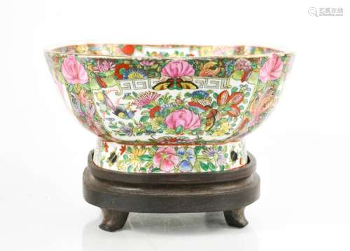 An early 20th century Chinese enamelled bowl on stand, depicting panels of flowers, birds and