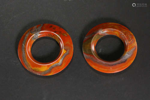 A PAIR OF CHINESE RED AGATE RINGS, WARRING STATES PERIOD