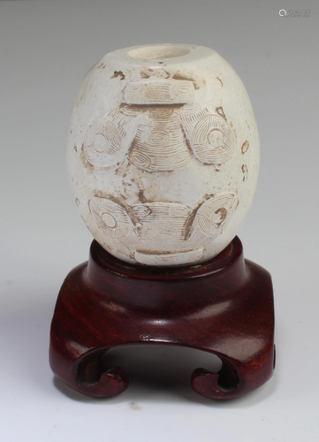 A Carved Jadestone Ornament with Stand