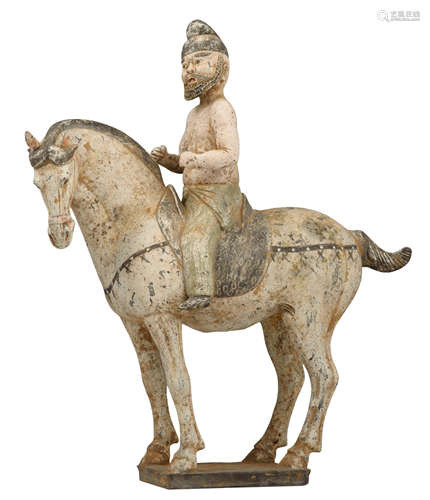 A cold painted Tang-type earthenware Ferghana horse with a foreign rider, H 42 cm