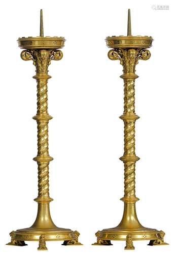 A pair of brass spindle-shaped Gothic Revival candlesticks, on three lion-shaped feet, H 80 cm