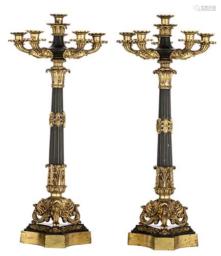 A pair of Neoclassical gilt and patinated bronze candlesticks, H 62 cm