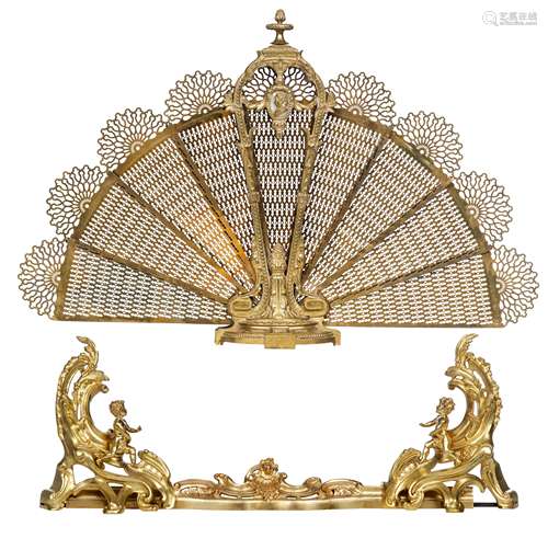 A brass Victorian style fan-shaped fire screen, decorated with Neoclassical ornaments and on top a m