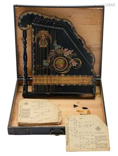 A belle ‚poque ebonised German 'harp-zither', decorated with a hand-painted eagle and Art Nouveau fl