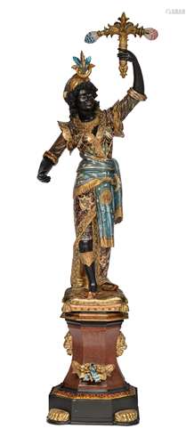 A Venetian polychrome painted and gilt wooden blackamoor torchŠre figure, dressed in an elaborately