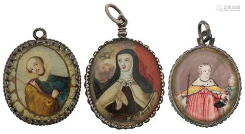 Three various recto-verso devotional pendant reliquaries with relics of St. Peter, St. Theresa, and