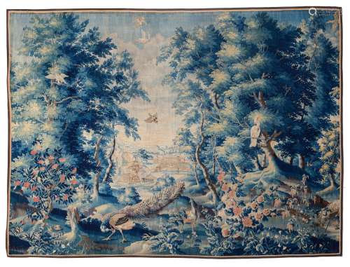 An 18thC verdure wall tapestry depicting peacocks, parrots and other birds in a landscape setting, w