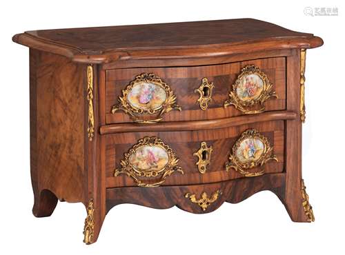 A walnut veneered Rococo style commode, decorated with gilt bronze mounts and hand-painted porcelain