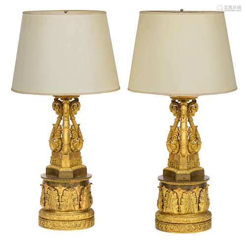 A fine pair of gilt bronze Empire style columns with lamps, in the manner of Thomire, decorated with