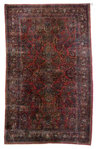 A large Oriental woollen rug, floral decorated, 306 x 511 cm
