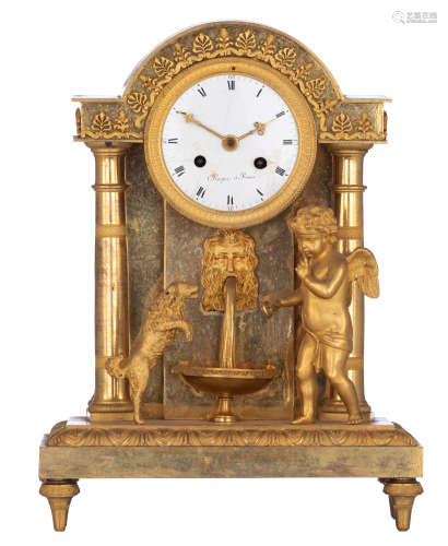A gilt bronze Directoire table clock, with an angel teaching a dog a trick, in an antique setting wi