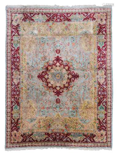 A large Oriental silk rug, floral decorated, the roundels in the border finely decorated with landsc