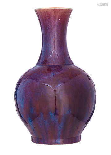 A Chinese sang-de-boeuf bottle vase, flamb‚-glazed in dark purplish-red tone with pale blue streaks,