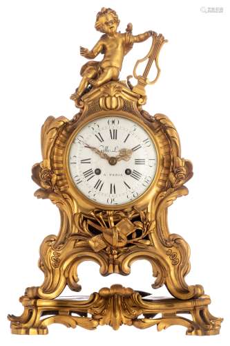 A Rococo Revival ormolu bronze cartel clock, decorated with a trophy and a putto holding a lyre on t