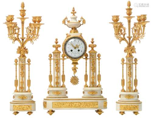A three-piece Louis XVI-style gilt bronze and Carrara marble clock garniture, the base decorated wit