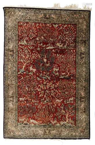 An Oriental silk carpet, decorated with various animals and birds in a landscape setting, 137 x 205