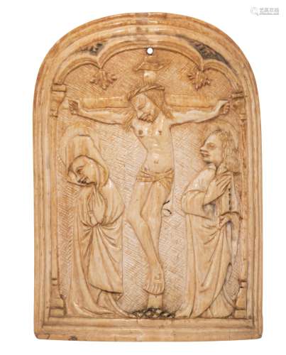 An ivory basso-relievo carved pax, depicting the Crucifixion, possibly 15thC, the Southern Netherlan