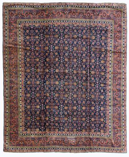 A woollen Kirman rug, decorated with flowers and geometric motifs, 275 x 325 cm