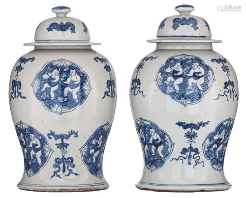 A pair of Chinese blue and white covered vases, the ogival panels decorated with a He-He boy, interc