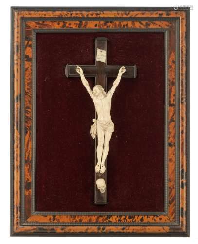 A richly sculpted ivory Baroque Corpus Christi on an ebonised crucifix, with the Memento Mori and th