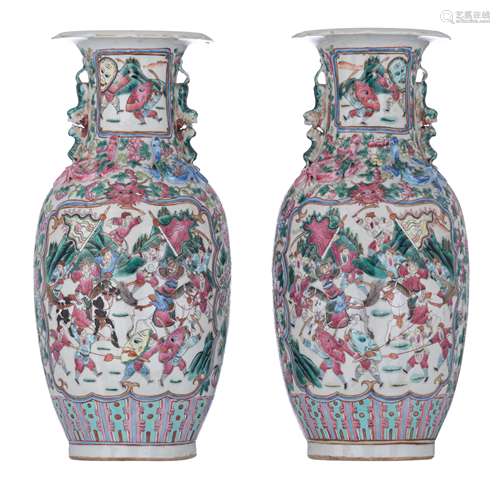 A pair of Chinese Canton famille rose vases, decorated with a battle scene, paired with Fu-lion hand