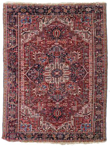 An Oriental woollen rug, decorated with geometric motifs, 240 x 325 cm