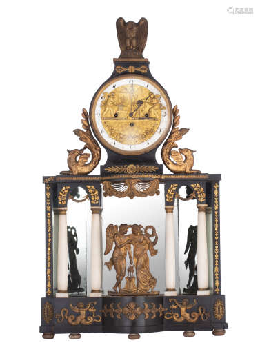 An ebonised wooden automaton Empire mantle clock, decorated with brass mounts, depicting to the fron
