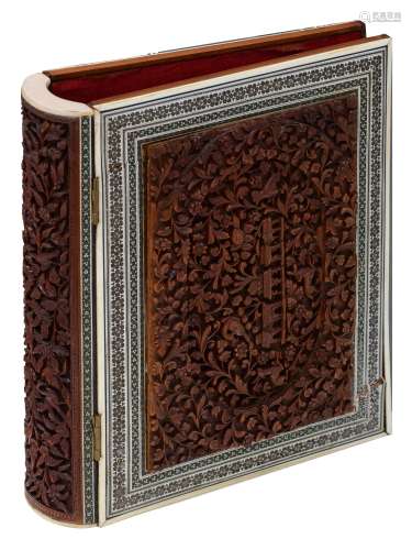 A Middle Eastern walnut book folder, with richly carved alto-relievo horror vacui panels, depicting