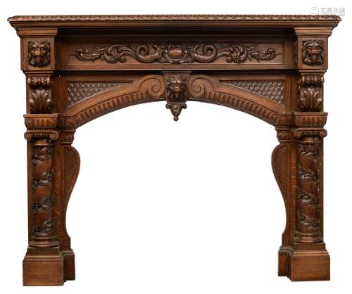 An imposing and richly carved oak Renaissance style fireplace mantle, decorated with scrollwork, lio