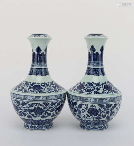 A PAIR OF BLUE AND WHITE FLORAL PORCELAIN VASES