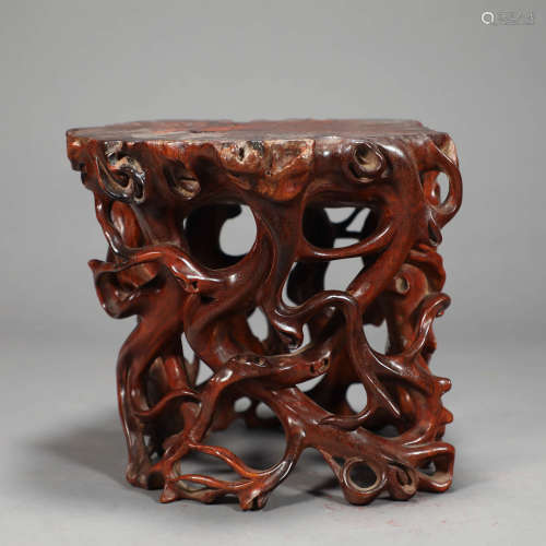 A HOLLOWED-OUT FRAGRANT ROSEWOOD STOOL
