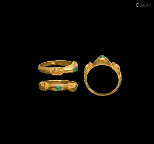 Gold 'Stirrup Ring' with Beast Heads and Emerald