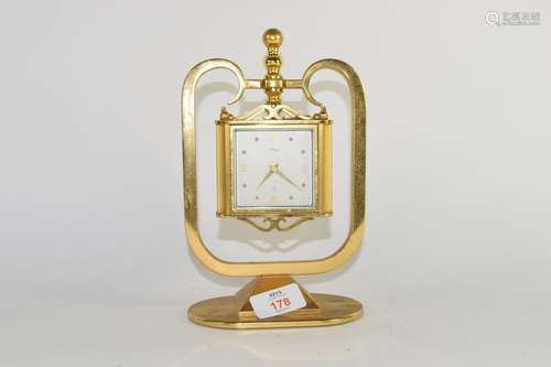 Brass model of a clock together with a barometer and hygrometer, German manufacture, in brass frame