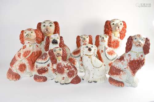 Group of nine Staffordshire dogs all decorated with sponged red decoration in typical fashion (9)