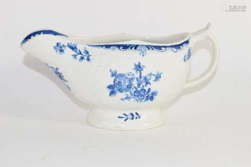 Lowestoft porcelain sauce boat decorated in blue and white with floral prints