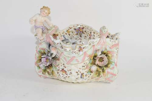 Late 19th century Continental porcelain basket with flower encrusted decoration and a cherub to