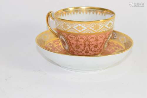 Early 19th century Coalport cup and saucer with a gilt design on salmon ground, pattern number