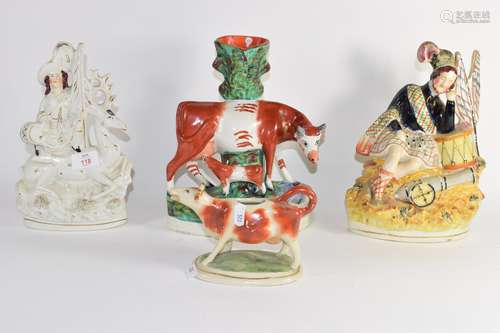 Group of Staffordshire figures including one of a soldier, group of cow and calf and a creamer (4)