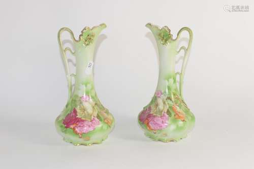 Pair of Continental pottery ewers with a floral design